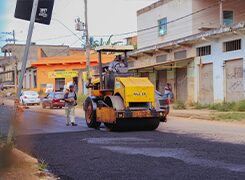 Tandem roller compacting fresh asphalt on a city street